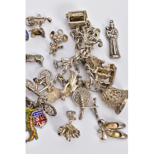 81 - TWO CHARM BRACELETS AND LOOSE CHARMS, the first a silver double curb link bracelet, fitted with nine... 