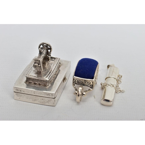 99 - THREE WHITE METAL ITEMS, to include a silver sewing needle box fitted with a sewing machine to the l... 