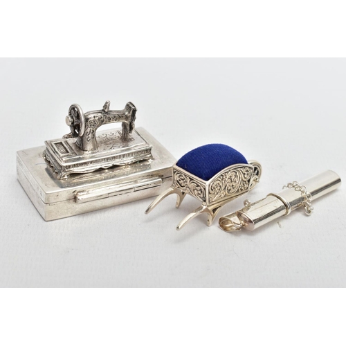 99 - THREE WHITE METAL ITEMS, to include a silver sewing needle box fitted with a sewing machine to the l... 