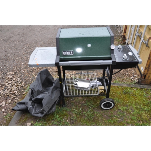 1217 - A WEBER SILVER GAS BARBECUE with two burners, side extension, undershelf, tools and cover enclosure,... 