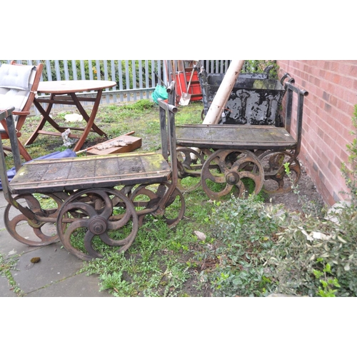 1223 - A PAIR OF CAST IRON OPEN PIT TROLLEYS with wooden iron banded beds, handles front and back with 4 ca... 