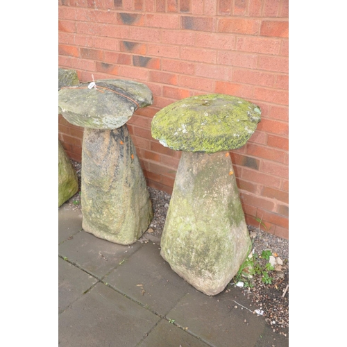 1226 - TWO COMPOSITE STADDLE STONE BASES one with a round sandstone top (with some age) the other with a re... 