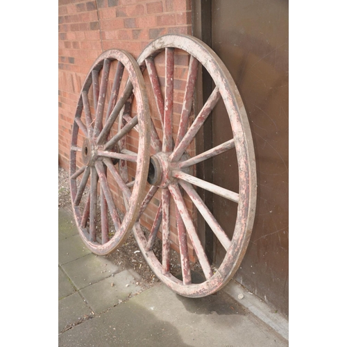 1227 - A PAIR OF VINTAGE WOODEN CARTWHEELS with iron banded rim and hub centre, diameters 168cm (some paint... 