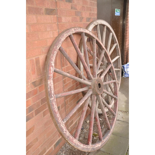 1227 - A PAIR OF VINTAGE WOODEN CARTWHEELS with iron banded rim and hub centre, diameters 168cm (some paint... 