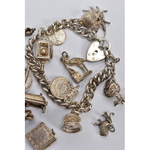 102 - TWO SILVER CHARM BRACELETS AND LOOSE CHARMS, the first a curb link chain each link stamped sterling,... 