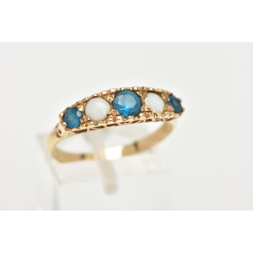 107 - A 9CT GOLD FIVE STONE RING, set with a row of three circular cut blue stones, interspaced with two c... 