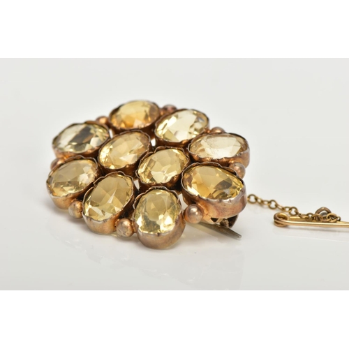 114 - A GILT CITRINE BROOCH, of an oval form set with ten oval cut citrines, each collet mounted with inte... 