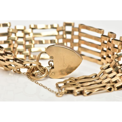 118 - A WIDE 9CT GOLD GATE BRACELET, five bar gate bracelet approximate width 16.4mm, fitted with a heart ... 