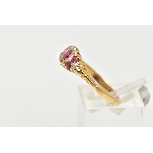 120 - A YELLOW METAL RUBY AND DIAMOND RING, of a marquise shape set with a central circular cut ruby inter... 