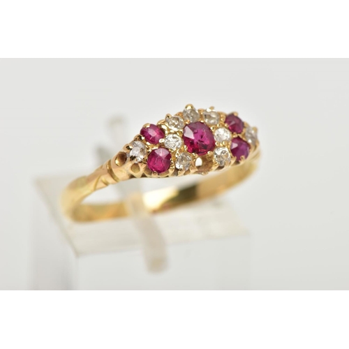 120 - A YELLOW METAL RUBY AND DIAMOND RING, of a marquise shape set with a central circular cut ruby inter... 