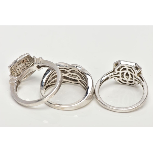 142 - THREE WHITE METAL DIAMOND SET DRESS RINGS, large dress rings each set with a variety of single cut a... 