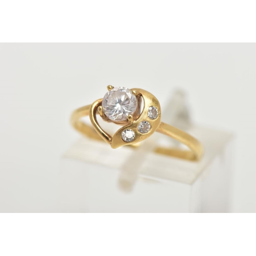 143 - A YELLOW METAL CUBIC ZIRCONIA DRESS RING, of an open heart design set with four colourless cubic zir... 