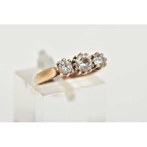 144 - A 9CT GOLD THREE STONE RING, set with three circular cut cubic zirconia, each in a claw setting, lea... 