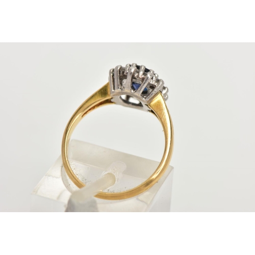 145 - AN 18CT GOLD SAPPHIRE CLUSTER RING, centring on an oval cut deep blue sapphire, claw set within a su... 