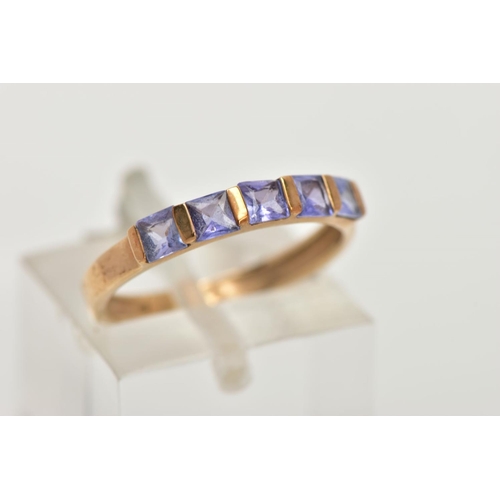 149 - A 9CT GOLD TANZANITE HALF HOOP RING, designed with a row of five bar set, square cut tanzanite's, le... 