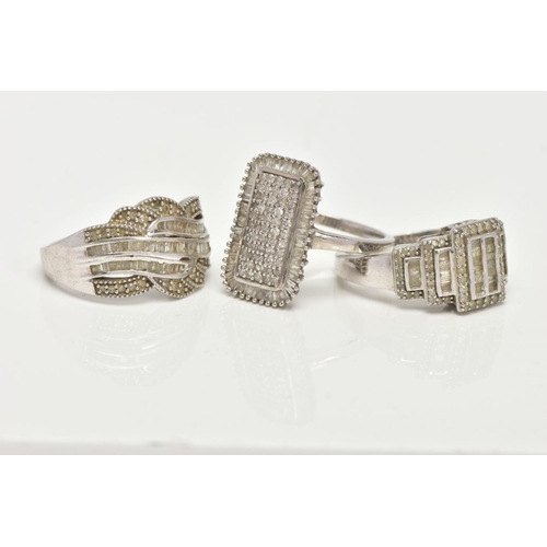 153 - THREE WHITE METAL DIAMOND SET DRESS RINGS, large dress rings, each set with single cut and tapered b... 