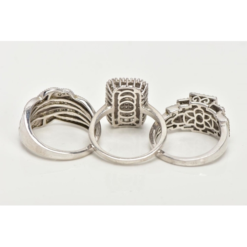 153 - THREE WHITE METAL DIAMOND SET DRESS RINGS, large dress rings, each set with single cut and tapered b... 