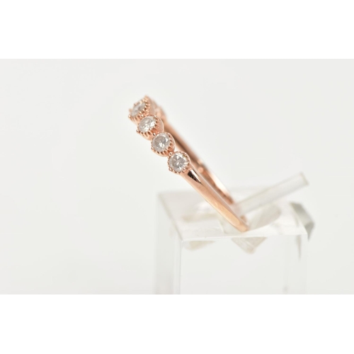 155 - A 9CT ROSE GOLD DIAMOND HALF ETERNITY RING, designed with a row seven round brilliant cut diamonds, ... 