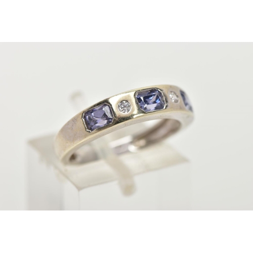 156 - A 9CT WHITE GOLD HALF ETERNITY RING, designed with a row of three rectangular cut light purple cubic... 