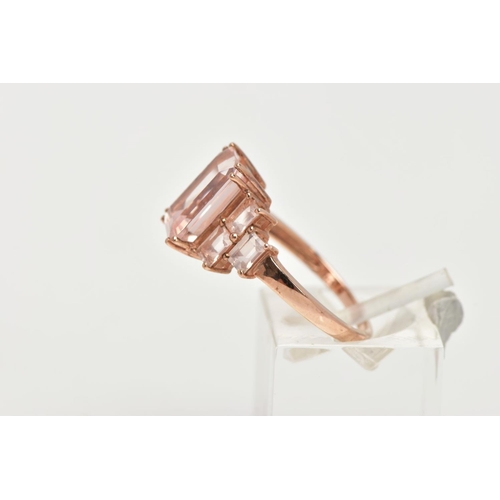 158 - A 9CT ROSE GOLD MORGANITE DRESS RING, of a tiered design, set with a central rectangular cut morgani... 