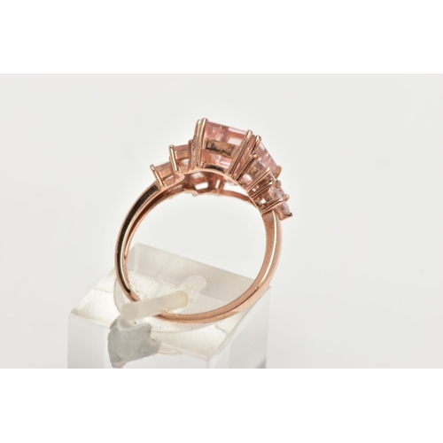 158 - A 9CT ROSE GOLD MORGANITE DRESS RING, of a tiered design, set with a central rectangular cut morgani... 