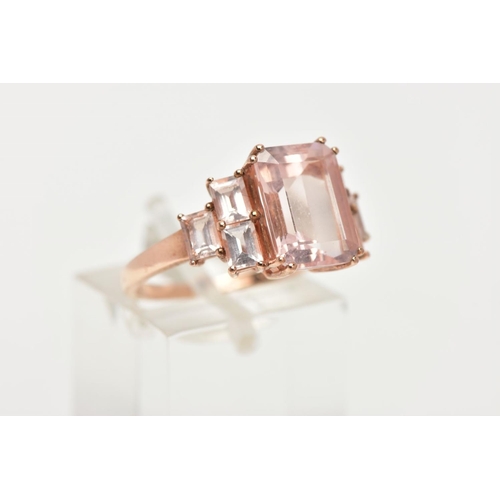 158 - A 9CT ROSE GOLD MORGANITE DRESS RING, of a tiered design, set with a central rectangular cut morgani... 