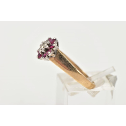 168 - A 9CT GOLD RUBY AND DIAMOND CLUSTER RING, flower shape cluster set with a central round brilliant cu... 