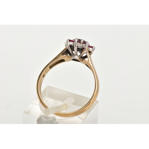 168 - A 9CT GOLD RUBY AND DIAMOND CLUSTER RING, flower shape cluster set with a central round brilliant cu... 