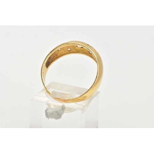 170 - A YELLOW METAL RING, wide band set with seven circular cut colourless cubic zirconia stones each in ... 