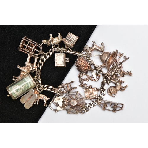 171 - A SILVER CHARM BRACELET, curb link bracelet fitted with twenty charms in forms such as a money holde... 