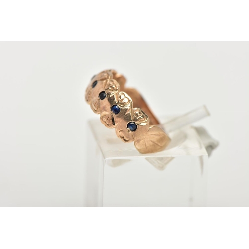 172 - A 9CT GOLD SAPPHIRE RING, a wide gold band ring with a floral engraved design, flush set with seven ... 