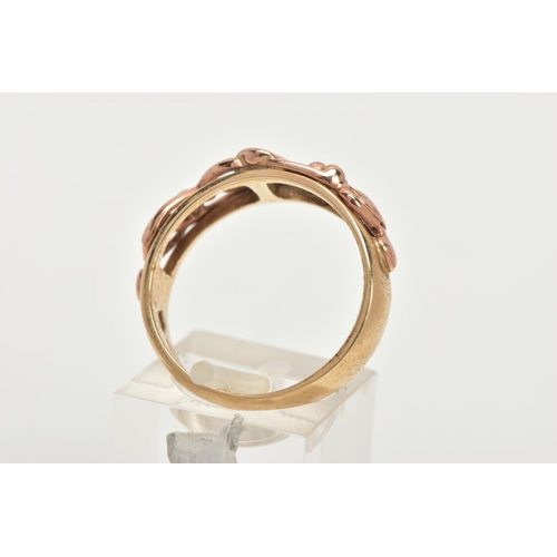 174 - A 9CT GOLD CLOGAU RING, a plain polished yellow gold band with an open work entwined foliage design ... 