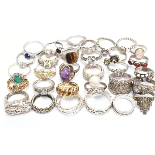 186 - AN ASSORTMENT OF SILVER AND WHITE METAL RINGS, a silver gold plated dome ring, hallmarked Birmingham... 