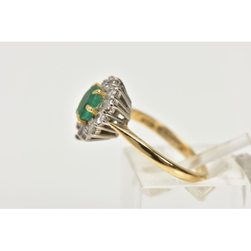 199 - AN 18CT GOLD  MID TO LATE TWENTEITH CENTURY EMERALD AND DIAMOND CLUSTER RING, centring on an oval em... 