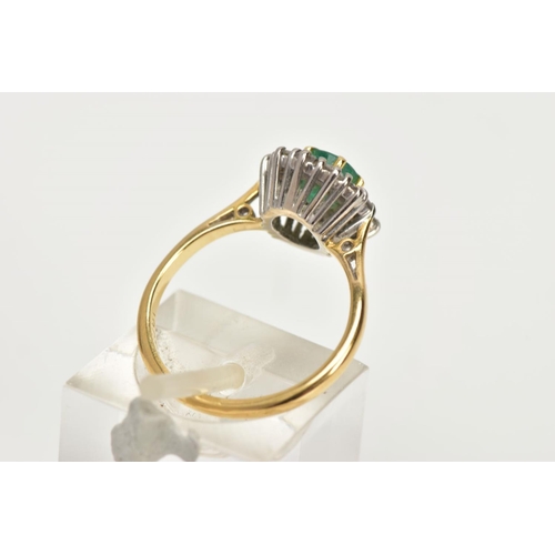 199 - AN 18CT GOLD  MID TO LATE TWENTEITH CENTURY EMERALD AND DIAMOND CLUSTER RING, centring on an oval em... 