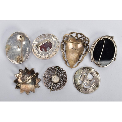 214 - A SCOTTISH SILVER BROOCH AND ASSORTED WHITE METAL BROOCHES, a round open work brooch featuring a lio... 