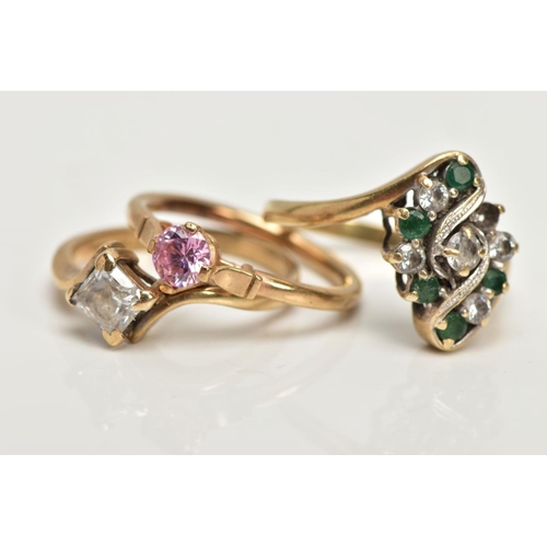 229 - THREE 9CT GOLD DRESS RINGS, the first a lozenge shape set with circular cut emeralds and colourless ... 