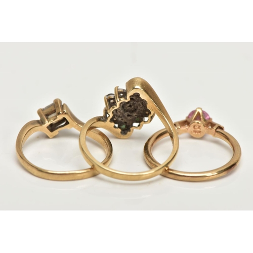 229 - THREE 9CT GOLD DRESS RINGS, the first a lozenge shape set with circular cut emeralds and colourless ... 