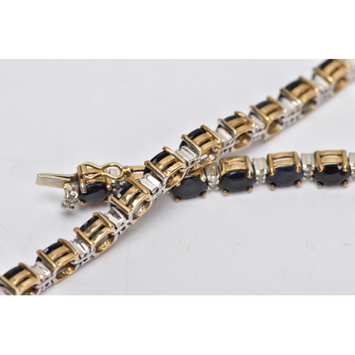 230 - A 9CT GOLD SAPPHIRE AND DIAMOND LINE BRACELET, designed with twenty-six oval cut deep blue sapphires... 