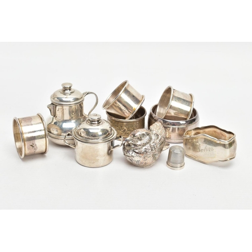 255 - AN ASSORTMENT OF SILVER AND WHITE METAL ITEMS, to include a silver napkin ring engraved with a folia... 