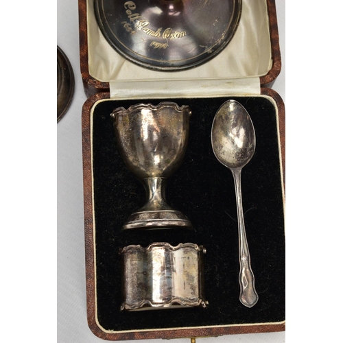 259 - A SELECTION OF SILVER ITEMS, to include a silver christening set, a napkin ring, egg cup and teaspoo... 