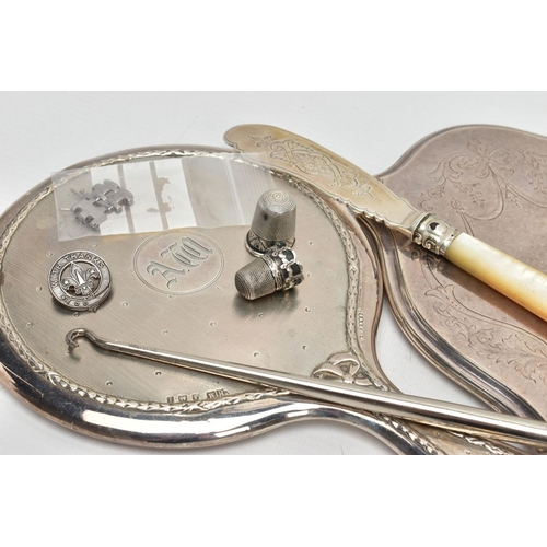 264 - TWO SILVER VANITY MIRRORS, BUTTON HOOK, CUTLERY AND THIMBLES, the first mirror of a circular form, e... 