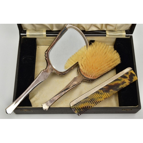 265 - A CASED SILVER VANITY SET, black case which opens to reveal a hair brush, mirror and a comb, each wi... 