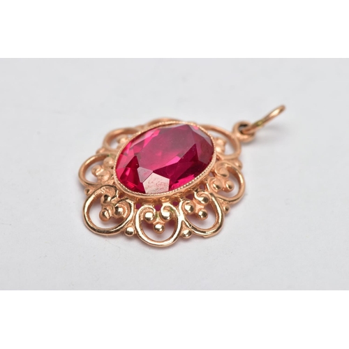 305 - A YELLOW METAL SYNTHETIC RUBY PENDANT, designed with a central oval cut synthetic ruby, approximate ... 