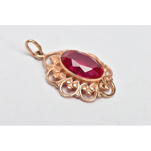 305 - A YELLOW METAL SYNTHETIC RUBY PENDANT, designed with a central oval cut synthetic ruby, approximate ... 