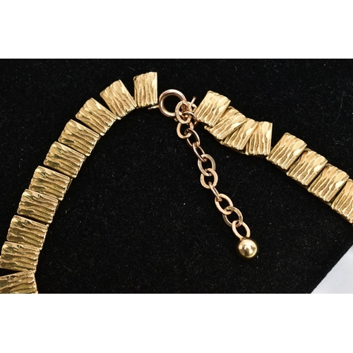 38 - A 9CT GOLD CLEOPATRA NECKLACE, textured gold panels interlinked together, fitted with a spring clasp... 