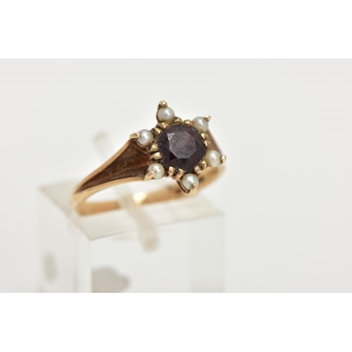 49 - A 9CT GOLD GARNET AND SEED PEARL CLUSTER RING, centring on a circular cut garnet double claw set wit... 