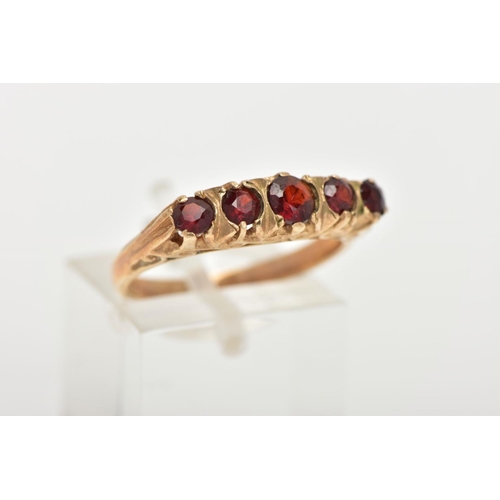 51 - A LATE 20TH CENTURY FIVE STONE GARNET RING, designed with a row of five slightly graduated, circular... 