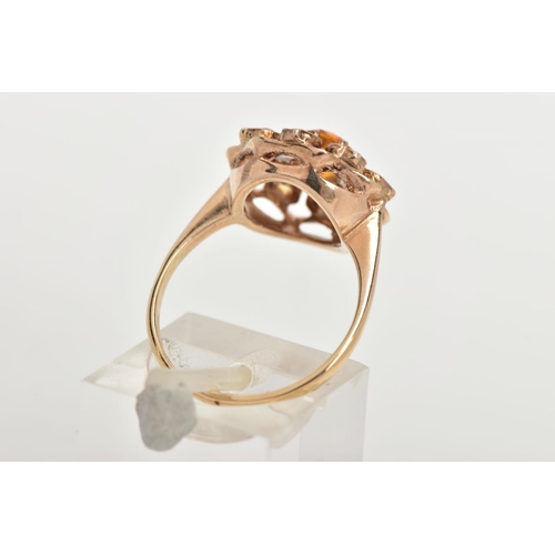 55 - A 9CT GOLD CLUSTER RING, in the form of a flower, set with a central circular cut orange stone asses... 