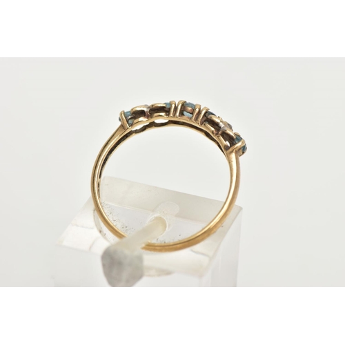 56 - A 9CT GOLD GEM SET HALF HOOP RING, designed with a row of five circular cut aquamarines, cross detai... 